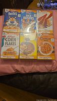 Front view showing six mini cereal box puzzles each with 50 pieces, featuring Frosties, Rice Krispies, Special K, Corn Flakes, Cocoa Pops, and Crunch Nut cereals.