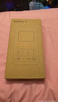 Photo of the new WisePad 3 box showing minimalist printed outline of the device with keypad and screen