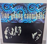 Album cover of Fine Young Cannibals featuring band members and blue geometric background.