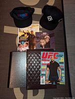 Two black hats, Top Gun DVD, magazine, album and newspaper clipping in the lot