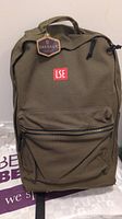 Front view of a new olive green backpack with LSE logo and Oakdale brand tag attached.