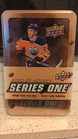 Front of sealed Upper Deck 2022-23 Hockey Series One hockey card tin featuring player image and branding.