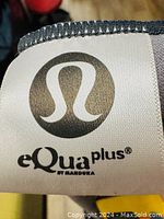 Close-up of Lululemon logo tag on the towel with 'eQua plus by Manduka' text
