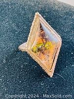 Photo of vintage sterling silver ring with diamond-shaped top and Tahitian scene