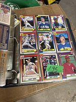 Photo showing baseball cards in binder page with players from New York Mets and St. Louis Cardinals.
