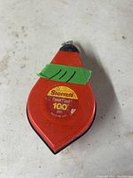 Red Starrett Reel Fast chalk line reel with 100 feet (30 meters) of line, showing the label and green tape with marks.
