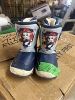 Front view of both boots showing Paw Patrol characters Chase and Marshall on boots front.