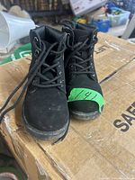 Front view of the pair of black lace-up boots with laces and size label.