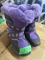 Front view of purple girls winter boots size 13M with floral and heart patterned velcro straps, lined with purple faux fur.