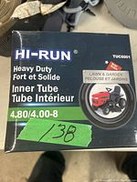 Close-up of Hi-Run branded box for a heavy duty lawn and garden inner tube showing product size 4.80/4.00-8 and a riding mower image on box.