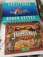 Photo showing two board games, Guesstures and Jumanji, both used with original boxes visible.