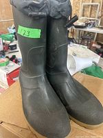 Front and side view of the pair of black rubber boots showing their general shape and features like the reinforced toe area and drawstring top.