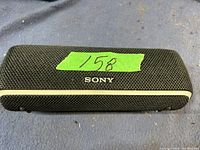 Front view of Sony Bluetooth speaker showing mesh grill and Sony logo.