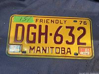 Single vintage Manitoba license plate from 1976 with registration stickers and brown lettering on yellow background.