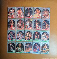Front view of 24 basketball cards arranged 6x4 showing players from Atlanta Hawks, Boston Celtics, and Miami Heat in action photos with team colors and logos.