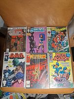 Six vintage comic books laid out on a surface showing front covers