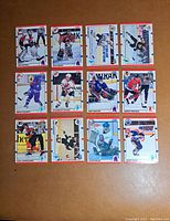 Front of 12 1981-82 Score hockey cards laid flat showing players in various actions.