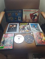 Spider-Man Limited Edition DVD gift set displayed with box, three DVDs (one disc missing), and two comic books, one being Amazing Fantasy.