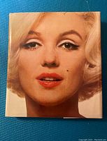 Front cover of the book showing a close-up portrait of Marilyn Monroe’s face.