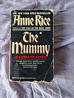 Front cover of 'The Mummy or Ramses the Damned' by Anne Rice, showing wear and creases.