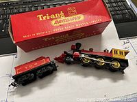 Photo showing the locomotive and tender next to the original red Tri-ang Railways box.