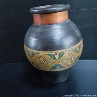 Front angle view of the terra cotta vase showing the hand painted decorative band and copper rim.