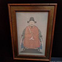 Full view of the framed portrait depicting Zuo Guangdou seated in traditional Ming Dynasty attire, showing the bamboo-style frame and inner gold trim.