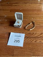 Lot overview showing pendant in box and bracelet