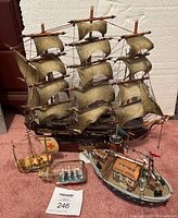 Front and side view of wooden sailboat models including Fragata Espanola, Lemax S.S. Islander, sailboat in bottle, and small sailboat