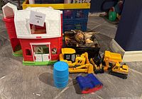 Little People barn, red silo, yellow toy tractors, blue barrel, assorted farm animals in black tray