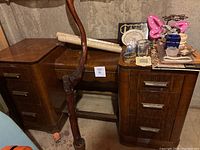Vanity table with tall decorative stick and small decor items on top