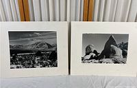 Two black and white photographic prints on white matt boards showing natural landscapes.