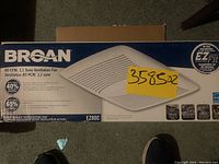 Front of product box showing model, airflow (80 CFM), noise rating (1.1 sone), and E-Z Fit installation system branding