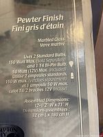 Close-up of lamp box label showing product specifications and features including pewter finish, marbled glass, bulb requirements, and assembled dimensions.