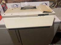 Full view of cream colored Air King range hood showing overall condition and structure.