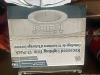 Box of T30 recessed lighting trims shown from top with product artwork and details visible.