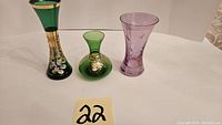 Photo showing all three small decorative glass vases arranged side by side.