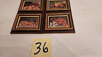 Four small framed pictures depicting fruit themes with soft material images, arranged in a square formation.