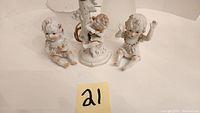 Porcelain baby figurines with porcelain baby-themed lamp base