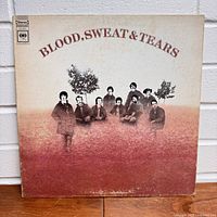 Front of album cover showing band members with trees and title 'Blood, Sweat & Tears'