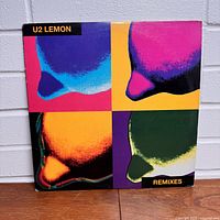 Front view of the vinyl album cover showing colorful pop art lemon design in four quadrants.