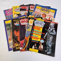 Overview photo of 10 vintage Official Doctor Who magazines arrayed in a fan shape showing various colorful covers