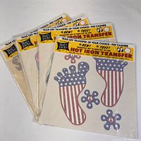 Set of four sealed vintage 1970s Rats Hole iron on T shirt transfers, each with patriotic print designs
