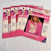Four unopened vintage Marilyn Monroe iron-on T-shirt transfer packages from 1990, showing front packaging with full color Marilyn Monroe design and model wearing a T-shirt with the transfer.
