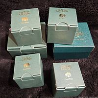 Six green Harmony Kingdom RarePoes boxes, slightly worn but unopened, stacked on a dark background showing branding.