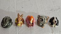 Lot includes a variety of five ceramic animal face pots: alligator, kangaroo, flamingo, koala, and spaniel dog, arranged on a light surface.