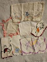 Overview of vintage doilies and napkins showing embroidery and crochet work