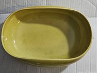 Top view of yellow oval Steubenville Pottery bowl showing interior surface and glaze condition.