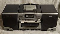 Full view of Aiwa CA-DW530 stereo with dual cassette decks and detachable speakers.
