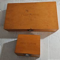 Closed wooden cases with 'Craftsman' stamped on lids, one larger and one smaller
